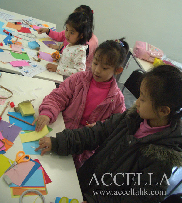 The children are completely focused on constructing their rabbitmobiles