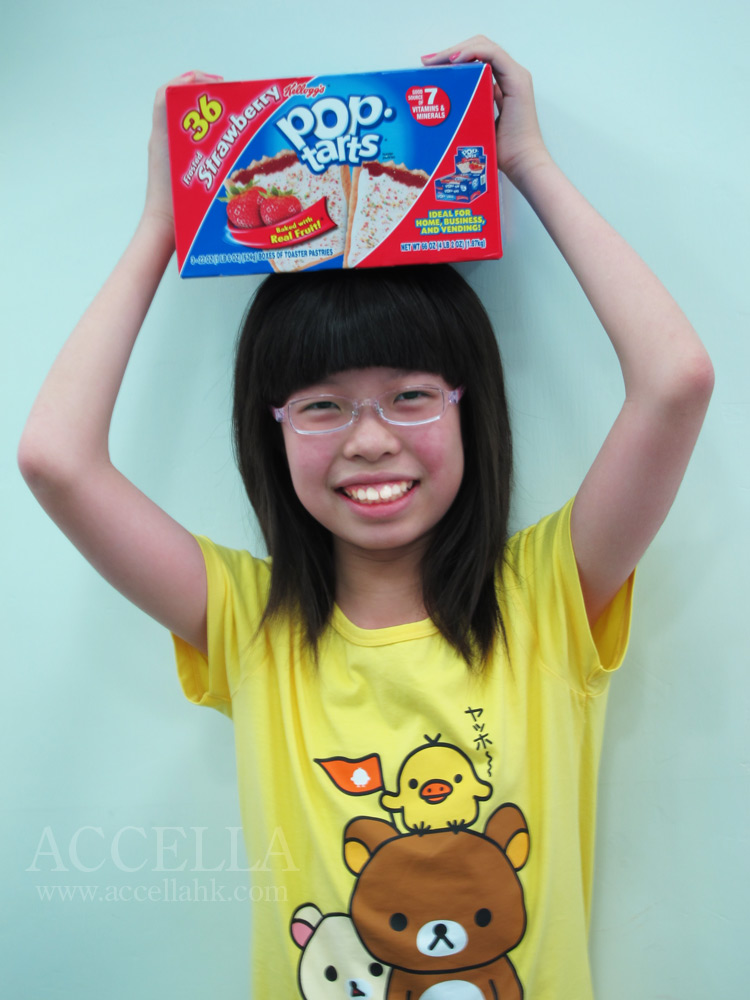 LeahC balancing a commercial-sized box of strawberry-flavored Pop-Tarts on her head.